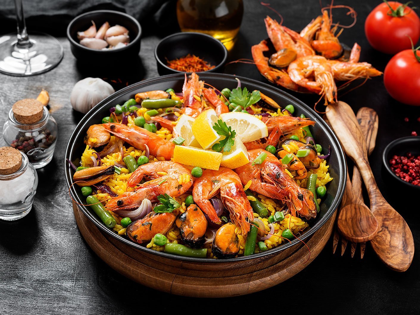 Traditional Spanish Seafood Paella In The Fry Pan On A Black Woo