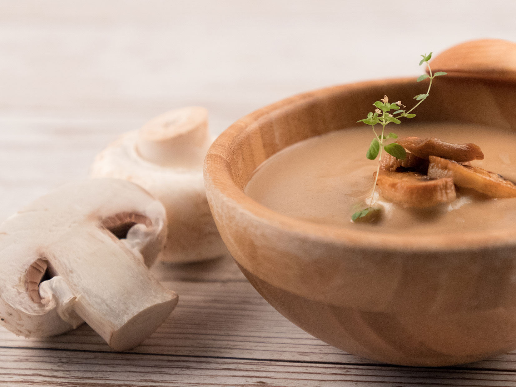 Mushroom Soup In Wooden Bowl With Roasted Mushrooms And Herbs On