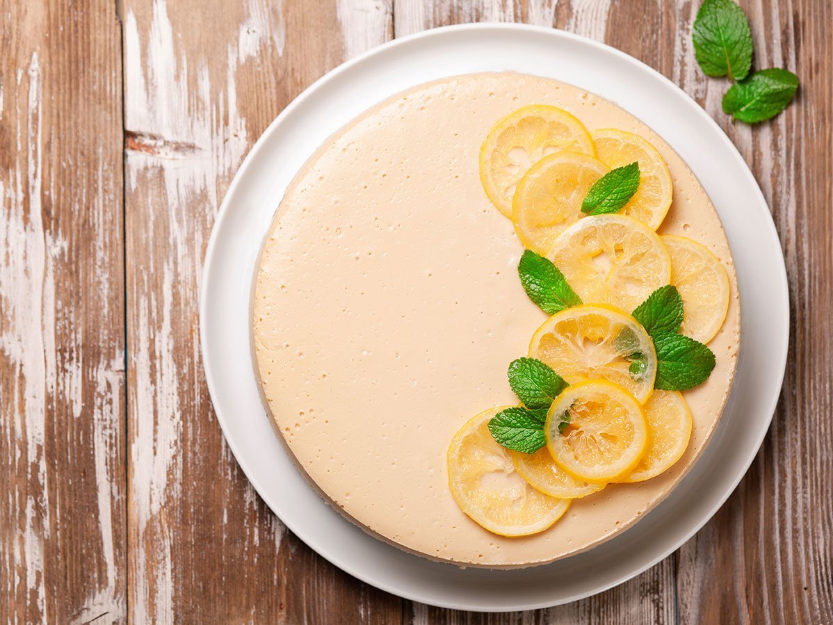 Top View Of Lemon Cheesecake Decorated With Citron And Mint On W