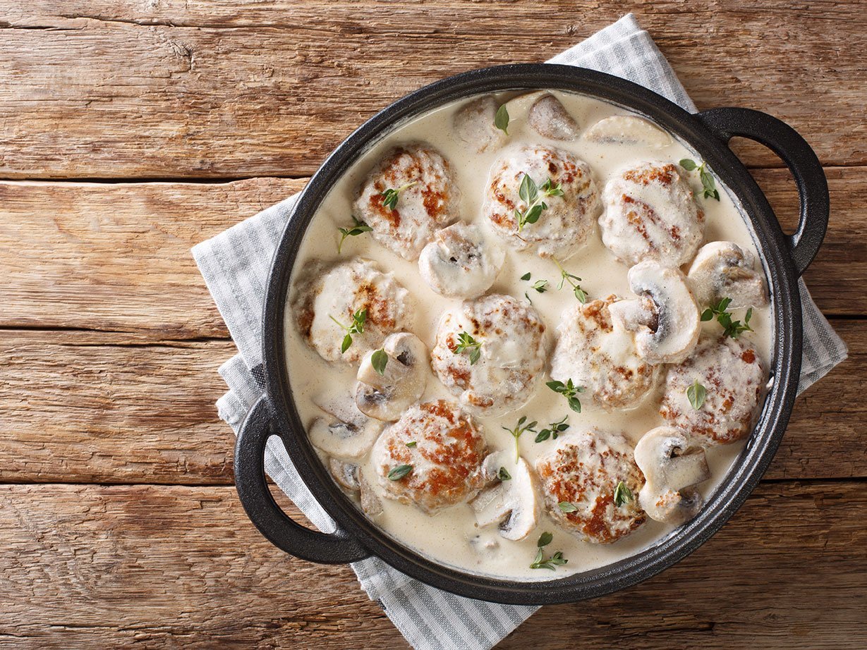 Main Dish Of Meatballs With Mushrooms Served In Creamy Cheese Sa