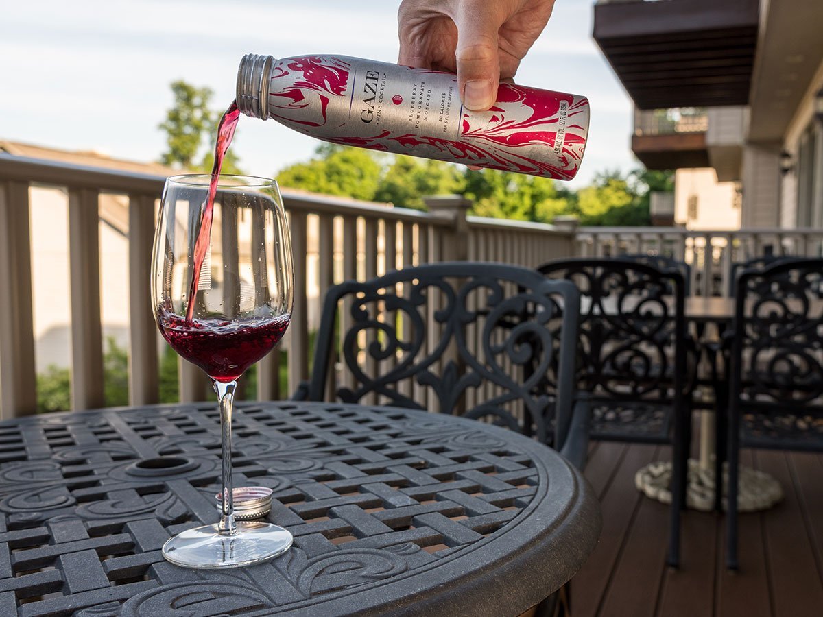 Can Of Gaze Wine Cocktail Being Poured Into Wine Glass On Outdoor Patio Or Deck