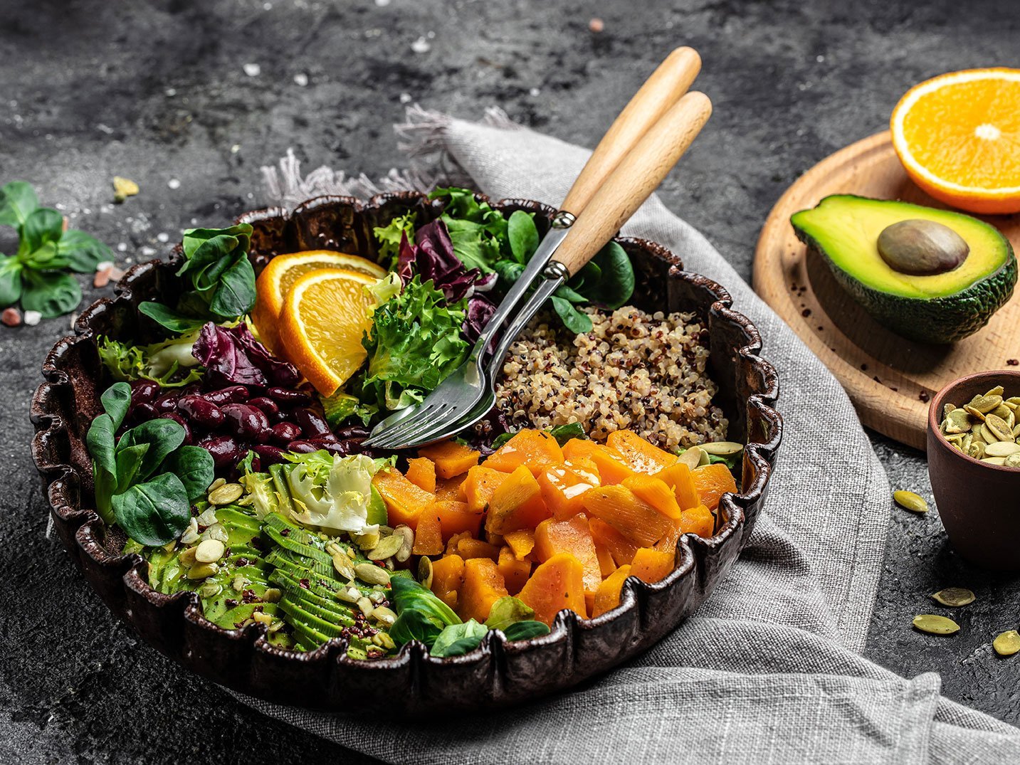 Quinoa Salad In Bowl With Avocado, Sweet Potato, Beans On Gray Background. Superfood Concept. Healthy, Clean Eating Concept. Vegan Or Gluten Free Diet. Top View