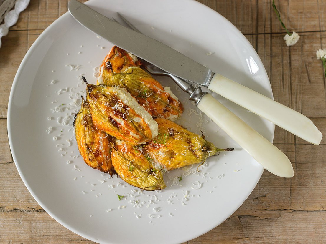 Stuffed With Ricotta And Cheese Baked Zucchini And Pumpkin Flowers Served With A Glass Of Mineral Water. Rutik Style.