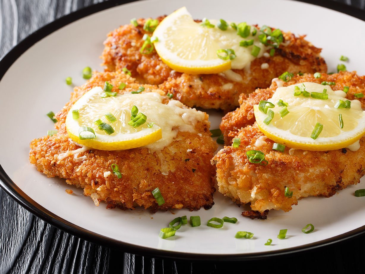 Romano Cheese Chicken Cutlet Fried Breaded Served With Lemon And