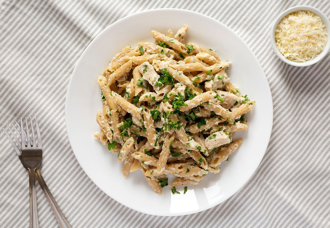 Homemade Chicken Alfredo Penne With Parsley On Cloth, Top View.