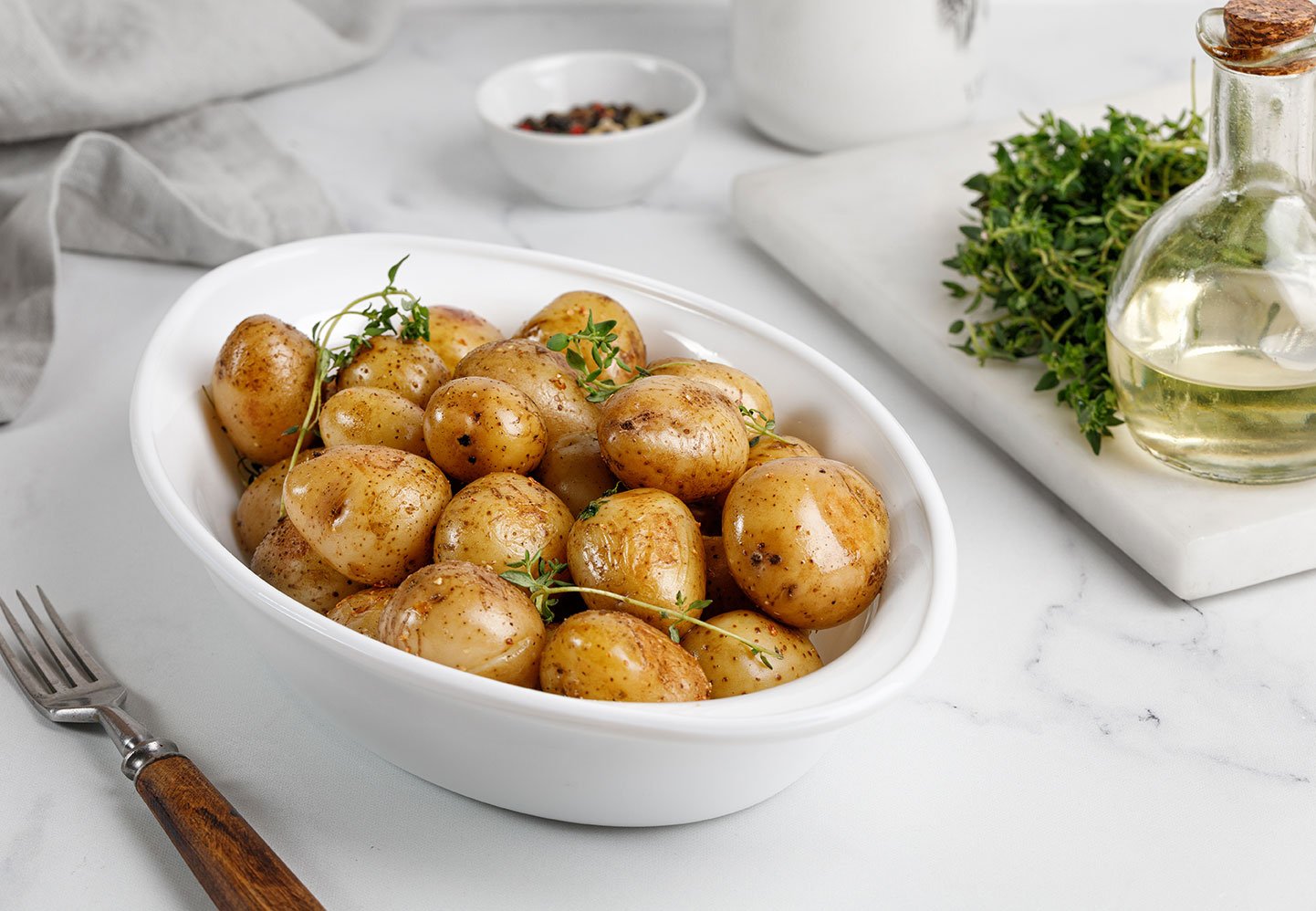 Young Roasted Baby Potato In A White Baked Dish On Mabrle Backgr