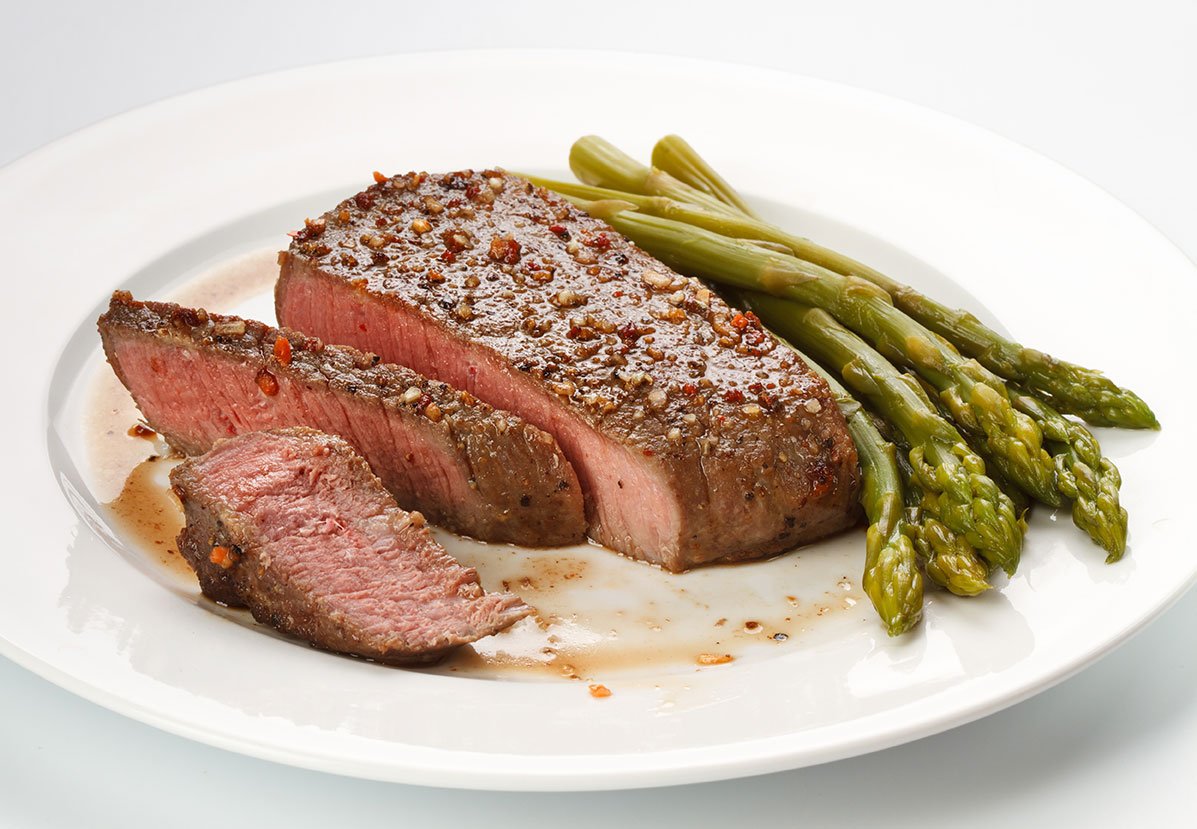 Grilled Steak With Green Asparagus On White Background