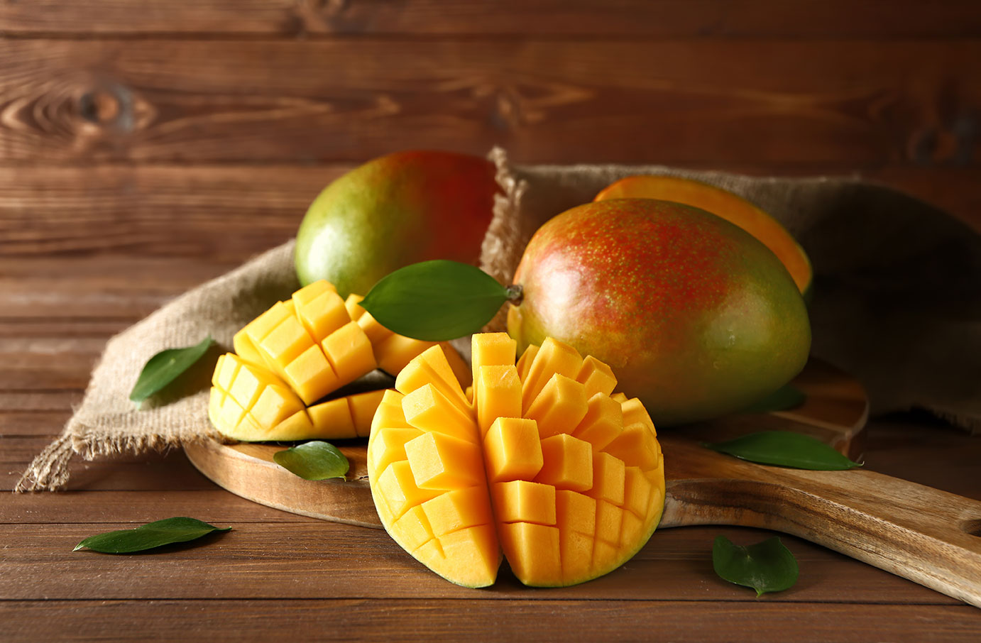 Board With Tasty Fresh Mango On Wooden Table