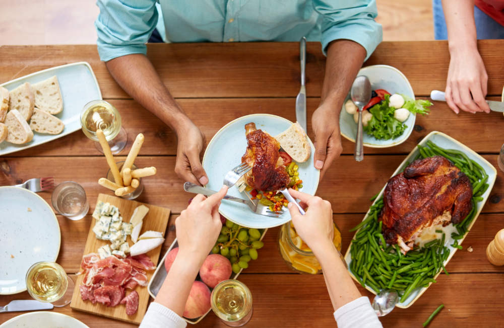 Group Of People Eating Chicken For Dinner