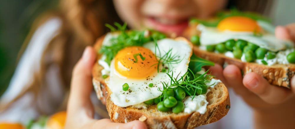 Kid Eating Delicious Breakfast Toasts With Fresh Healthy Ingredients