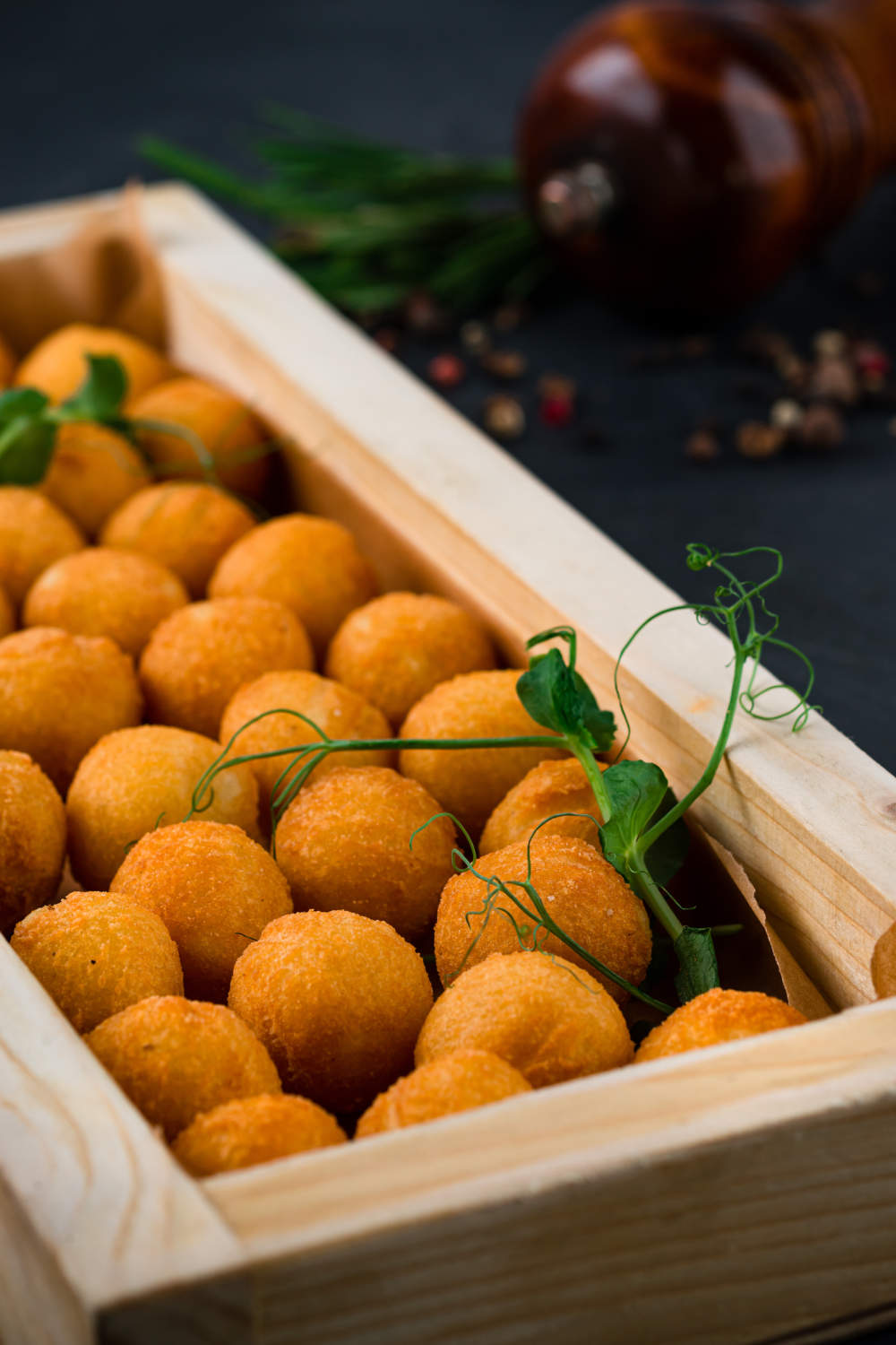 Croquettes, Fried Mashed Potato Served With Green Peas On A Wooden Board, Closeup.