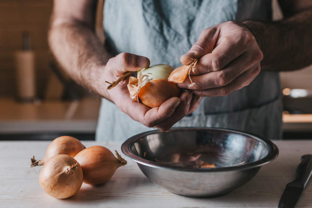 The Process Of Cleaning The Onion Peel Layer By Layer