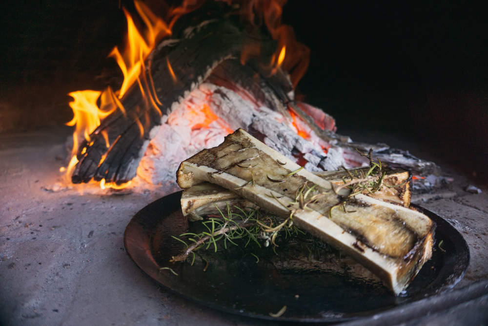 Dish Of Bone Marrow Roasted In A Rustic Wood Fired Oven