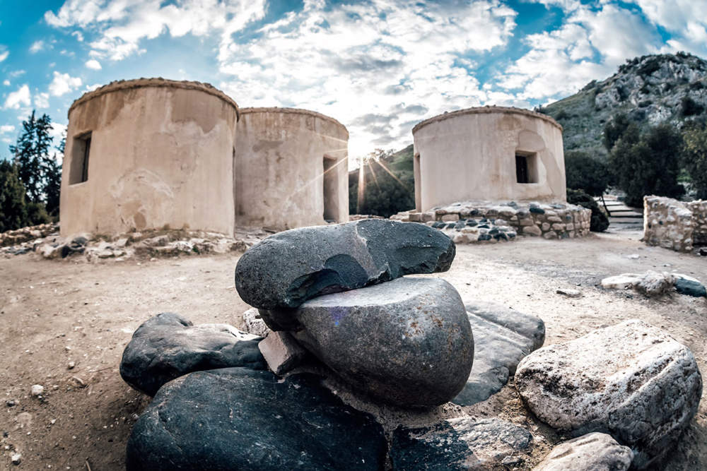 Reconstructed Round Houses Of Neolithic Era And Stone Tools At The Archaeological Site Of Choirokitia Settlement, Cyprus