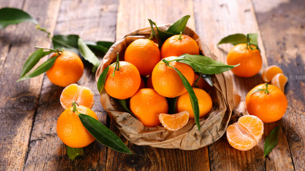 Clementine And Leaf On Wood Background