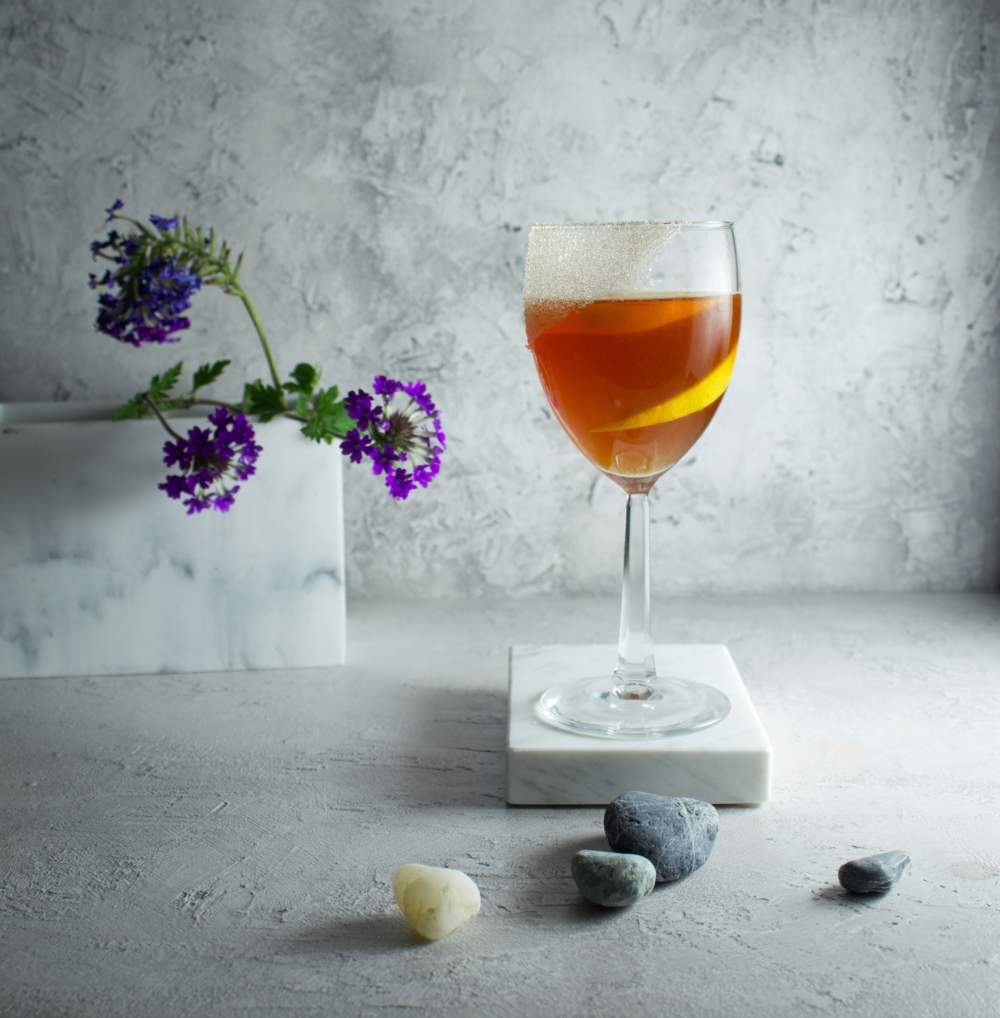 Brandy Crusta Orange Classic Cocktail Against A Textured White Grey Background