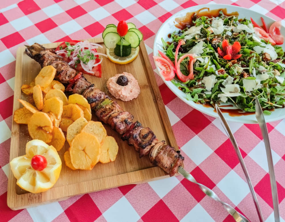 Greek Kontosouvli Large Souvlaki Made By Fresh Meat Grilled On Fire And Served With French Fries