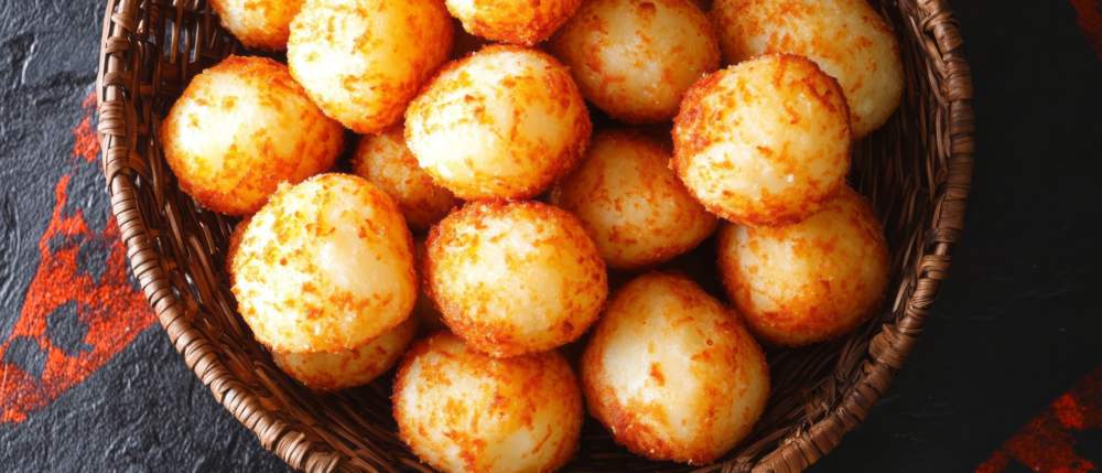 Crispy, Golden Brown Potato Balls In A Basket.