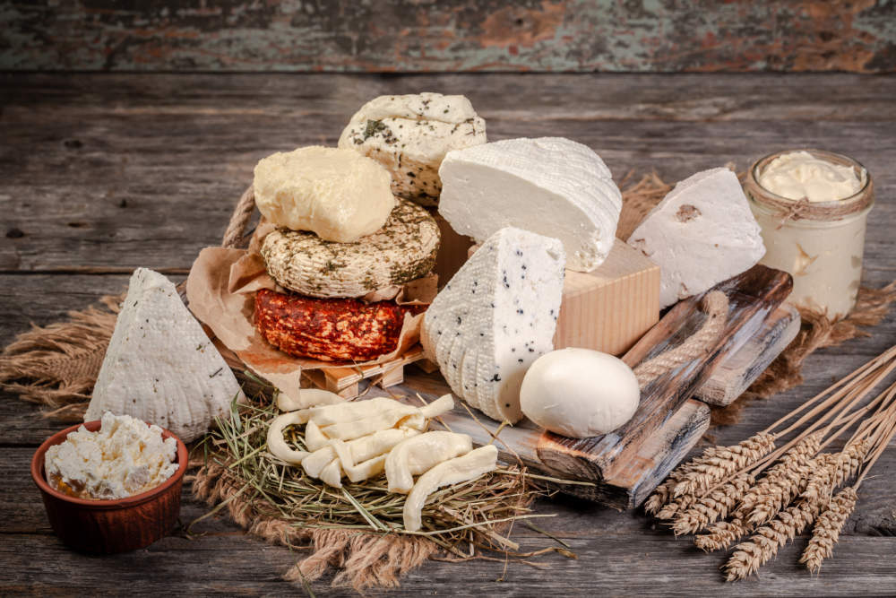 A Large Variety Of Cheeses On Rustic Background