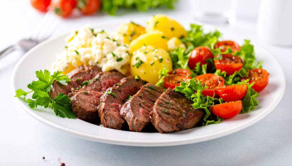 Tasty Sliced Steak With Creamy Potato Salad And Roasted Cherry Tomatoes. Tasty Food. Delicious Meal.