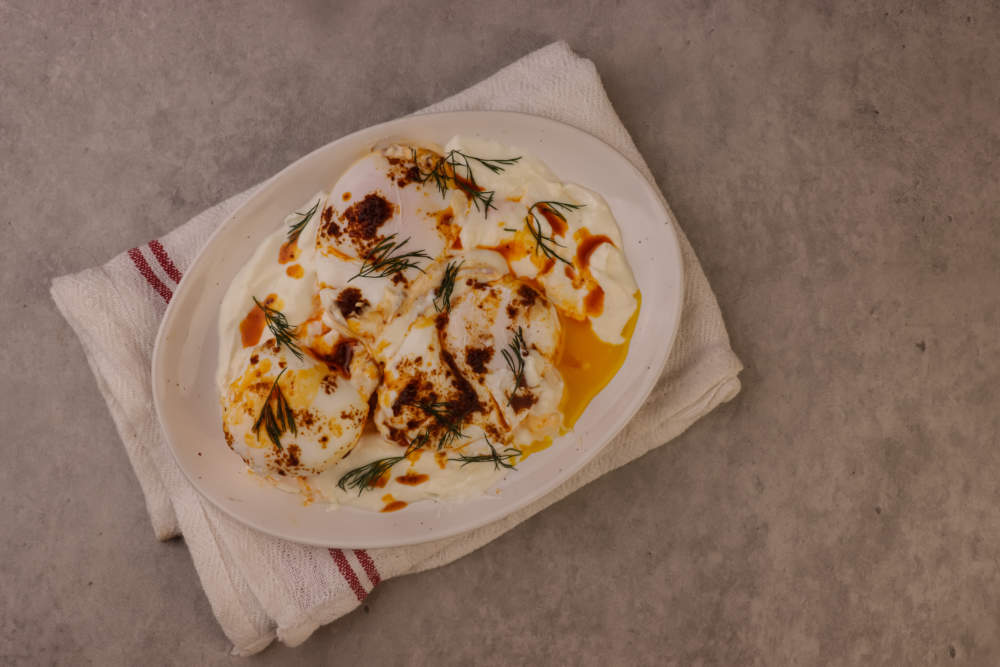 Cilbir Or Turkish Eggs Is Poached Eggs With Creamy Yogurt And Butter Sauce.