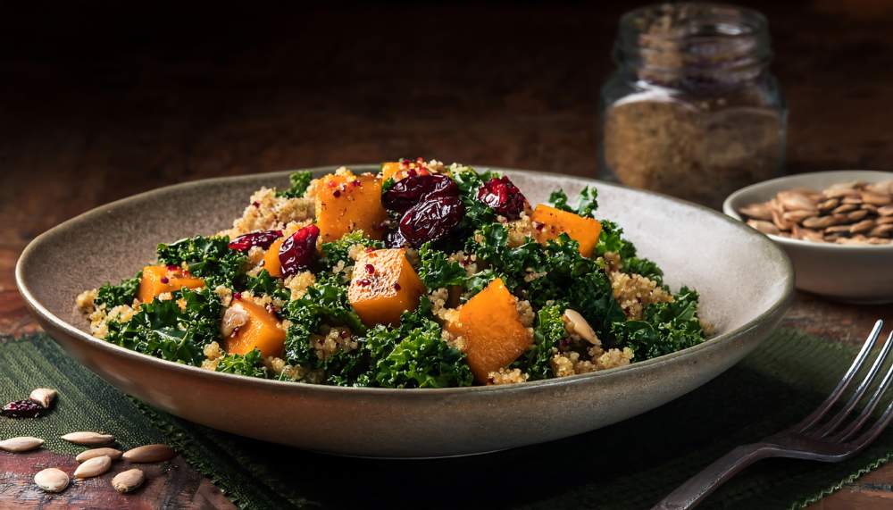 A Colorful And Nutritious Salad Featuring Roasted Sweet Potatoes, Quinoa, Kale, Cranberries, And Pecans, Perfect For A Fall Or Winter Meal