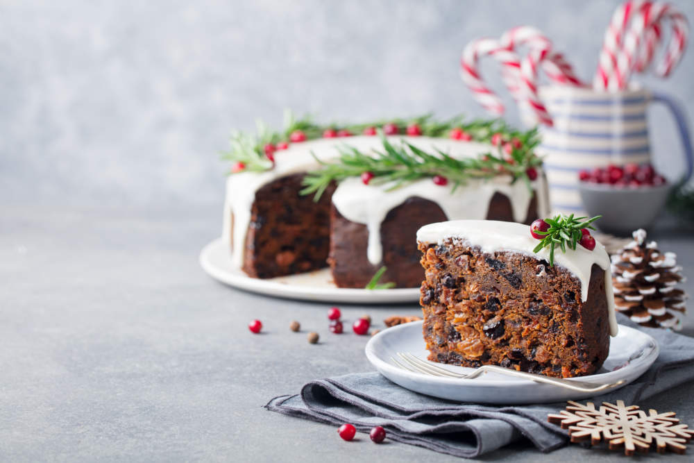 Christmas Fruit Cake, Pudding On White Plate. Traditional New Year Dessert. Copy Space.